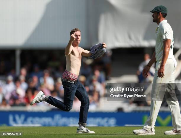 Spectator runs onto the field of play during Day Three of the LV= Insurance Ashes 5th Test Match between England and Australia at The Kia Oval on...