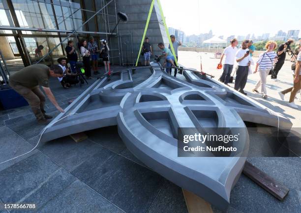 Ukrainian trident is seen before workers prepare of install it at the shield of the Motherland Monument at the World War II open air museum in Kyiv,...