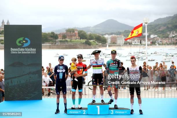 Romain Bardet of France and Team DSM - firmenich celebrates at podium as most combative prize winner, Pello Bilbao of Spain and Team Bahrain -...