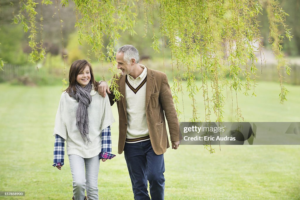 Man walking with his daughter in a park