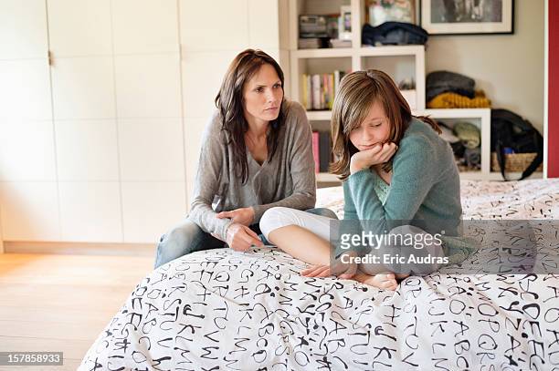 woman scolding her daughter in the bedroom - mother scolding stock pictures, royalty-free photos & images