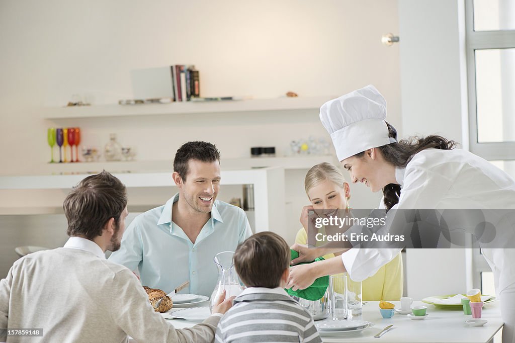 Woman serving lunch at dining table