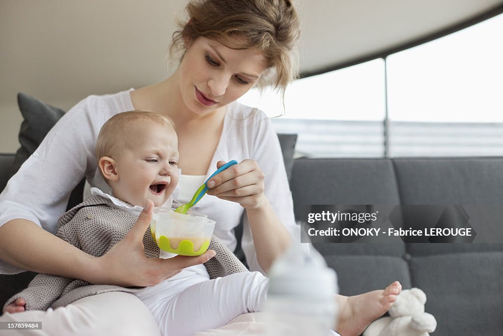 Woman feeding her daughter