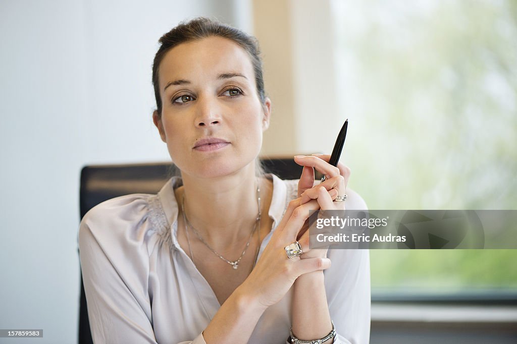 Close-up of a businesswoman thinking in an office