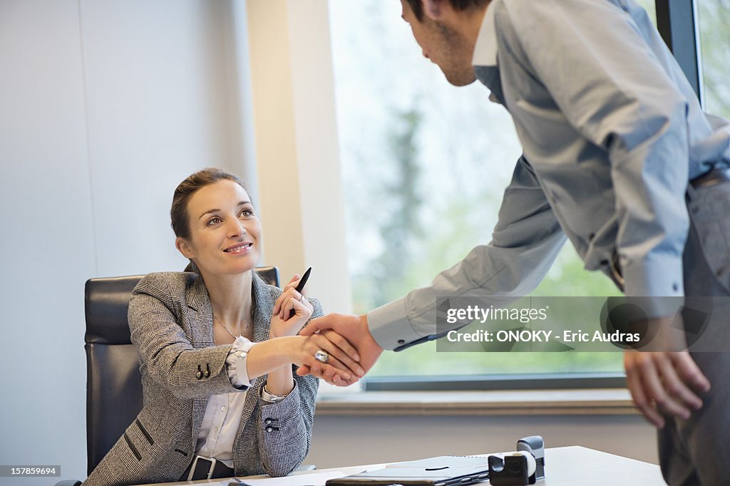 Business executive shaking hands with her client