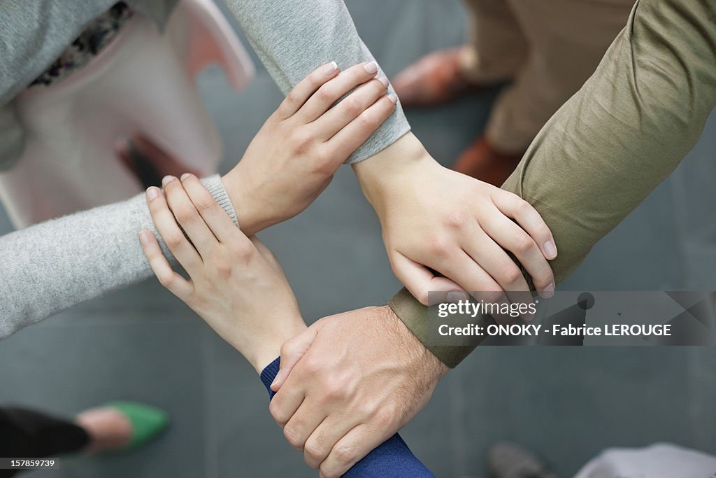 Close-up of connecting hands of business executives