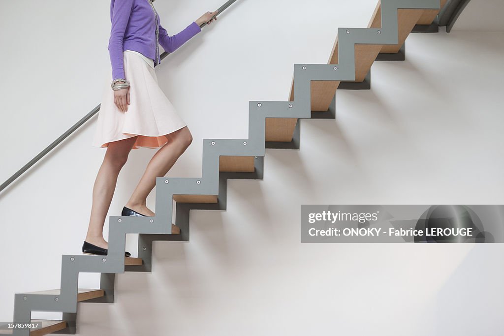 Woman moving up stairs