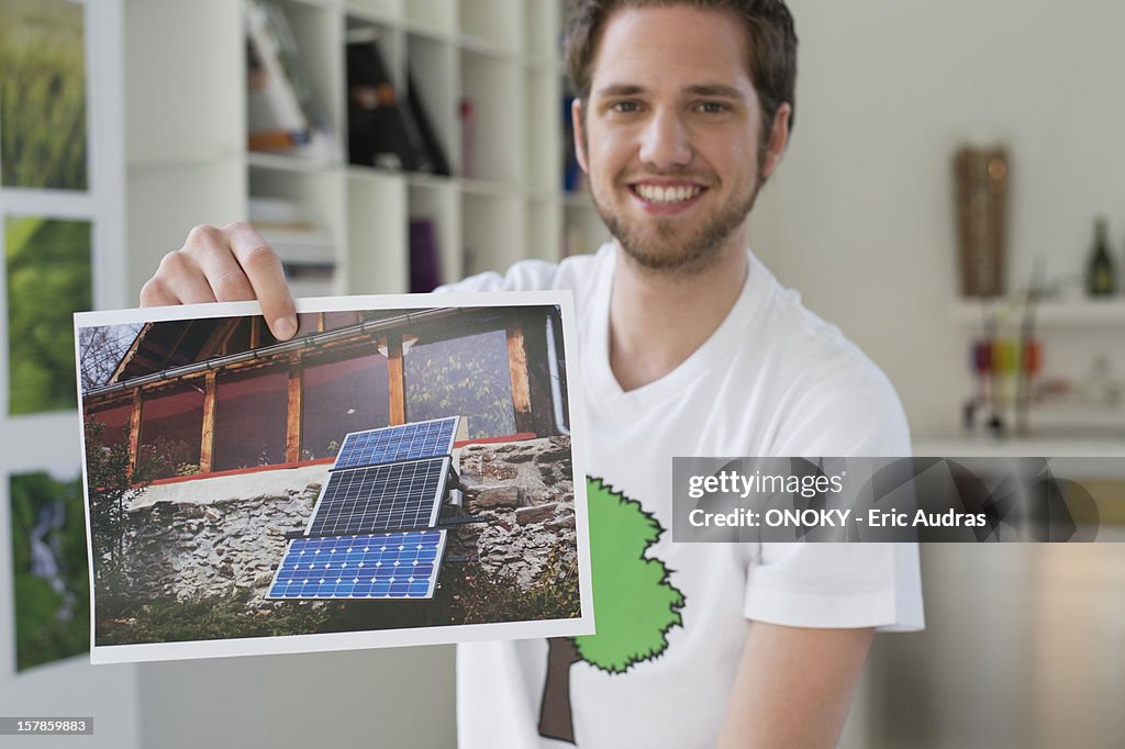 Man showing an ecological poster of solar panel