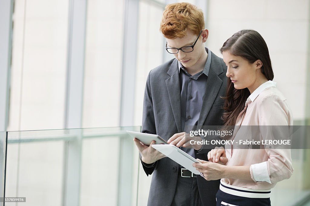 Business executives using digital tablets in an office