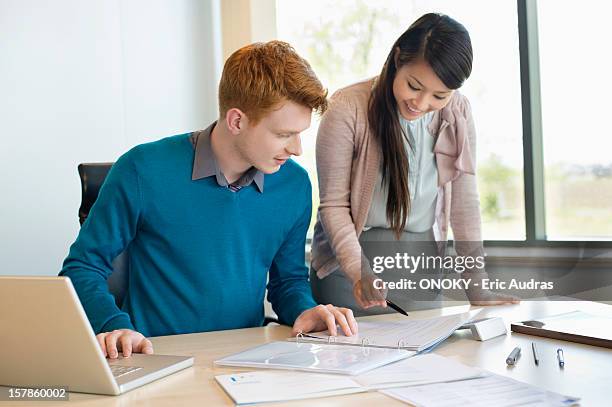 businessman examining documents with his secretary - secretary stock pictures, royalty-free photos & images