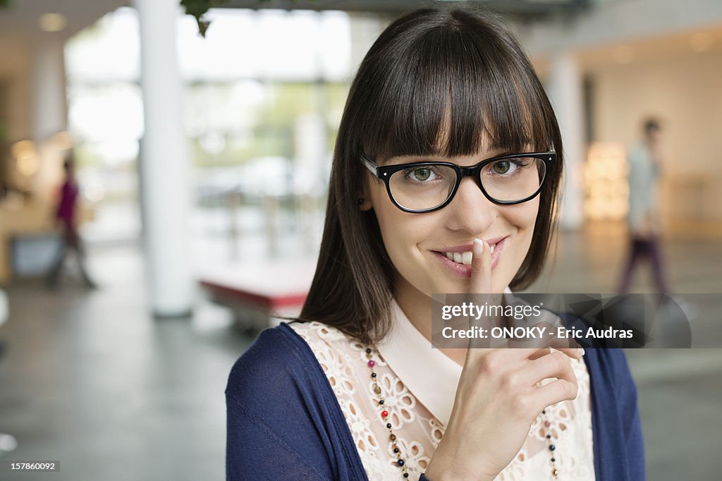 Portrait of a businesswoman with finger on lips