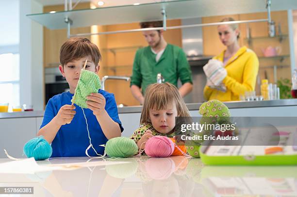 boy and his sister playing with woolen balls - ball of wool stock pictures, royalty-free photos & images