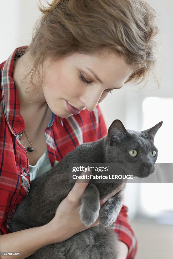 Close-up of a woman holding a black cat