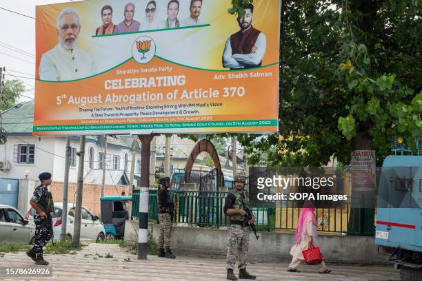 Indian paramilitary troopers stand on guard outside the venue as supporters of the Bharatiya Janata Party celebrate the fourth anniversary of the...