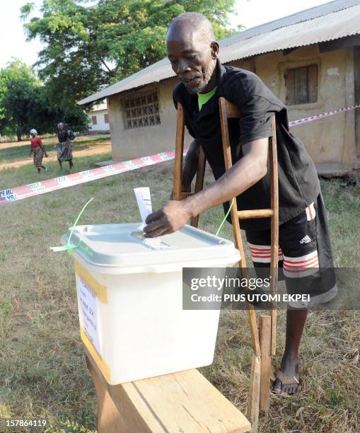 Man on crutches casts his vote at Talekura, Bole Bamboi constituency, in a northern region on December 7, 2012 as Ghana voted in a high-stakes...