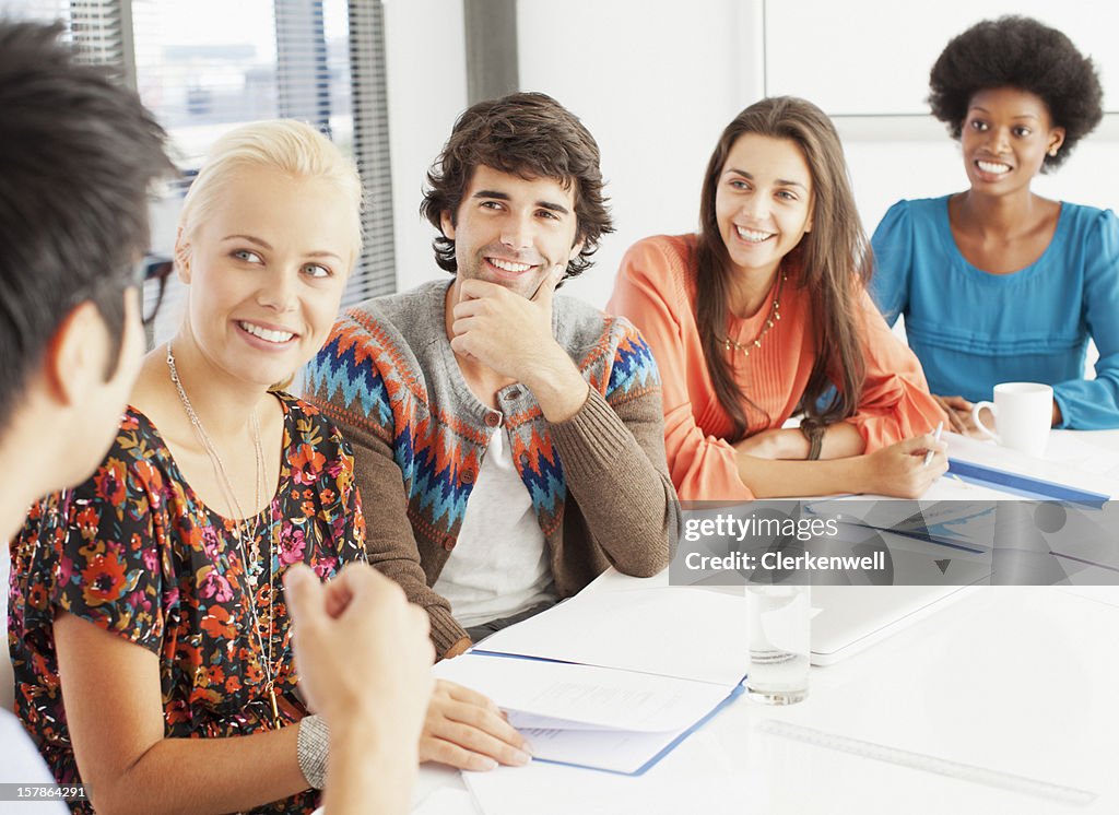 Smiling business people meeting in conference room