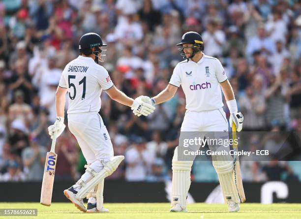 Joe Root and Jonny Bairstow of England shake hands as they get a 100 partnership during Day Three of the LV= Insurance Ashes 5th Test Match between...