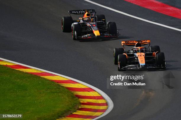 Oscar Piastri of Australia driving the McLaren MCL60 Mercedes leads Max Verstappen of the Netherlands driving the Oracle Red Bull Racing RB19 during...