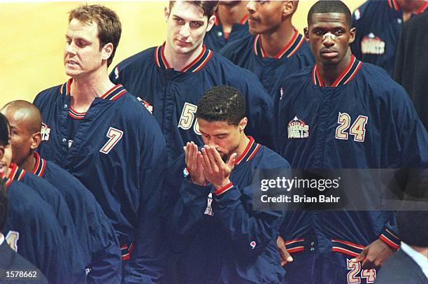Point guard Mahmoud Abdul-Rauf of the Denver Nuggets stands in prayer during the singing of the National Anthem before the Nuggets game against the...