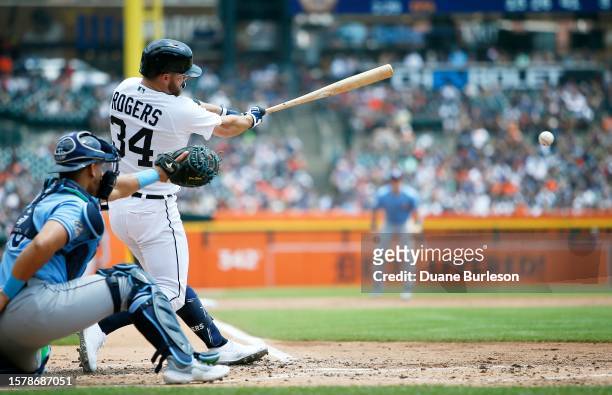 Jake Rogers of the Detroit Tigers singles to drive in Miguel Cabrera with catcher Rene Pinto of the Tampa Bay Rays behind the plate during the second...