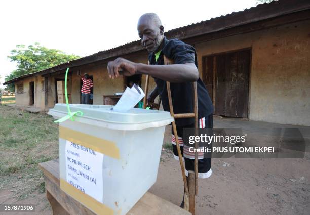 Man on crutches casts his vote at Talekura, Bole Bamboi constituency, in a northern region on December 7, 2012 as Ghana voted in a high-stakes...