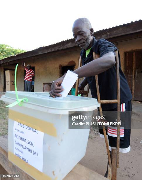 Man on crutches casts his vote at Talekura, Bole Bamboi constituency, in a northern region on December 7, 2012 as Ghana voted in a high-stakes...