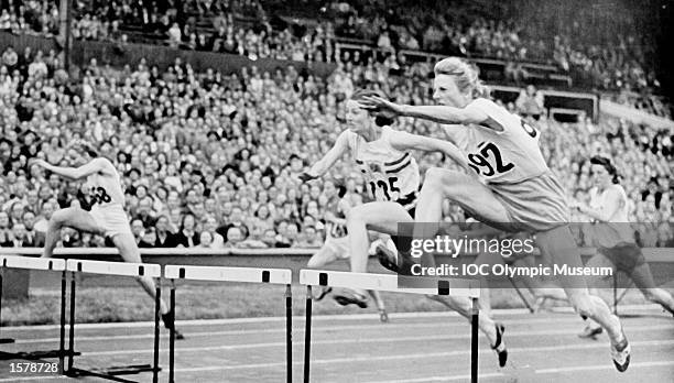 Fanny Blankers-Koen of Holland clears a hurdle on her way to winning the womens 100m hurdles at the 1948 Olympic Games in London. The dark-haired...