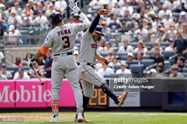 Jose Altuve of the Houston Astros celebrates hitting a home run with Jeremy Pena of the Houston Astros against the New York Yankees during the third...