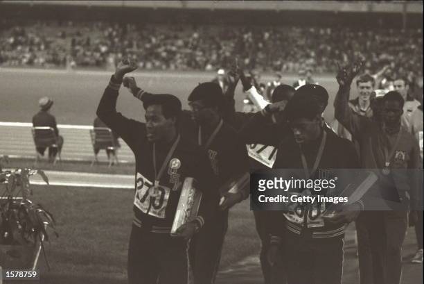 The USA team which won the 4 by 400 metres relay in a world record breaking performance leave the arena, holding aloft clenched fists, at the 1968...