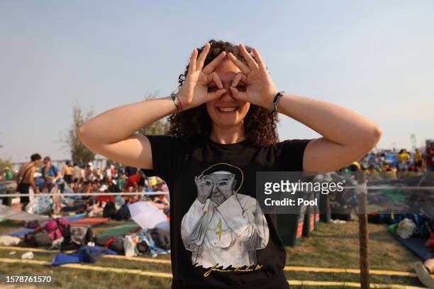 Pilgrim jokes with her t-shirt before the Holy Mass for World Youth Day at Parque Tejo on August 5, 2023 in Lisbon, Portugal. With a week of...
