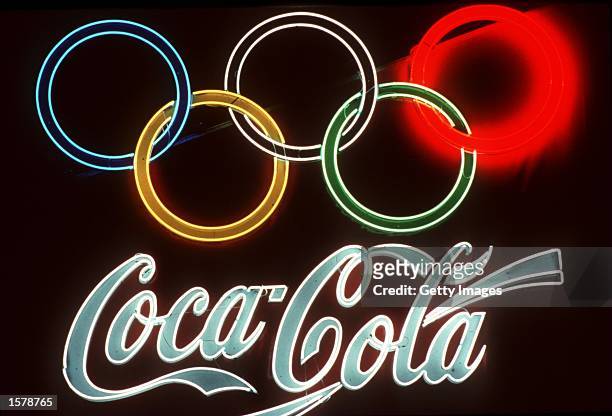 Neon signs of Olympic sponsor Coca Cola glows bright on a dark wall during the 1992 Olympic Games in Barcelona, Spain. Mandatory Credit: Allsport...
