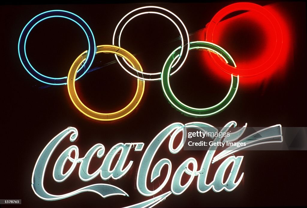 1992: A neon signs of Olympic sponsor Coca Cola glows bright on a dark wall during the 1992 Olympic