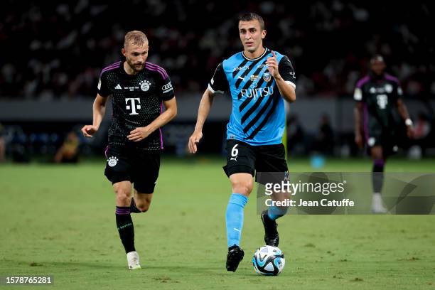Joao Schmidt of Kawazaki Frontale, left Konrad Laimer of Bayern Munich in action during the pre-season friendly match between Kawasaki Frontale and...