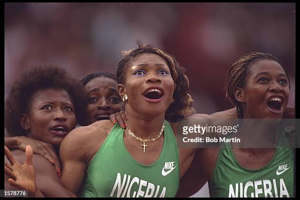 The womens 4x100m relay team of Nigeria start to celebrate as the watch a video replay of their race on the giant stadium screens and discover they...