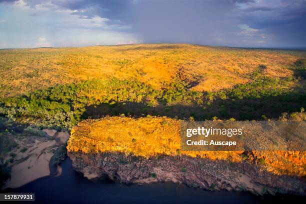 Early rain at the end of the dry season falls on savannah near Moll Gorge, Hann River, Marion Downs Wildlife Sanctuary, northern Western Australia.