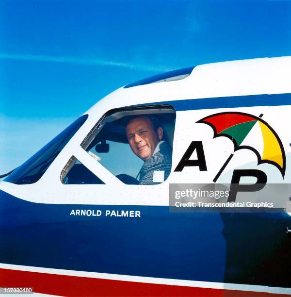 Arnold Palmer peers out the window of his personal airplane around 1965 in Latrobe, Pennsylvania.