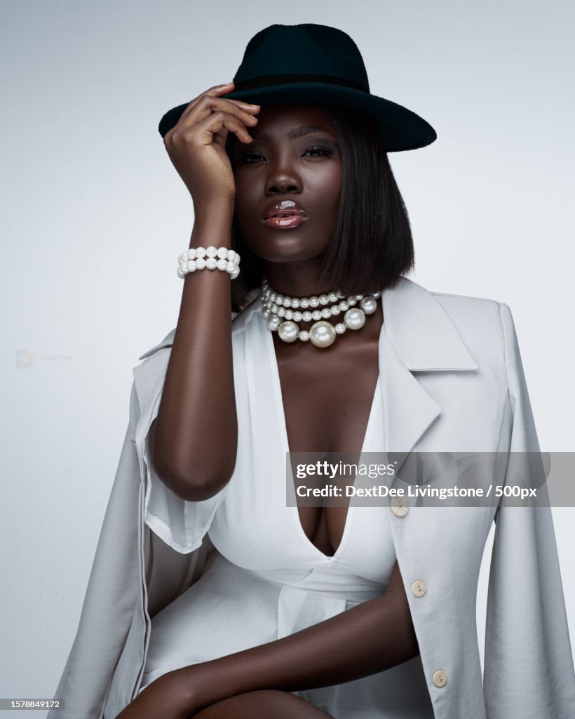 Portrait of fashionable young woman wearing black dress and leather jacket