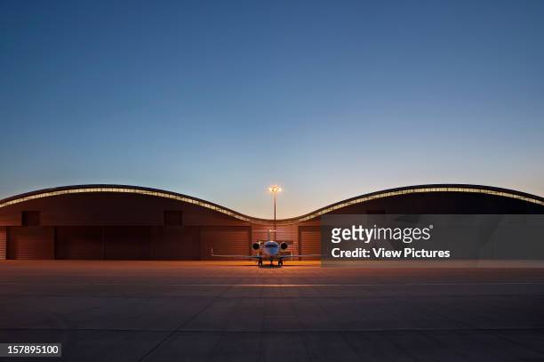 Tag Farnborough Airport, Farnborough, United Kingdom, Architect Reid Architecture, Tag Farnborough Airport Symetrical View Of Hangars At Twilight.