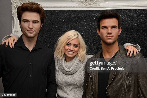 Pussycat Doll Kimberly Wyatt poses nexct to wax figures of Robert Pattinson and Taylor Lautner at Madame Tussauds on December 7, 2012 in London,...