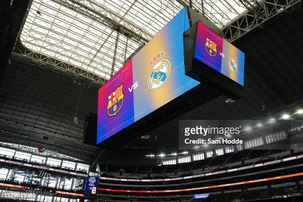 Center-hung scoreboard displays the logos of FC Barcelona and Real Madrid before the pre-season friendly match between the two teams at AT&T Stadium...
