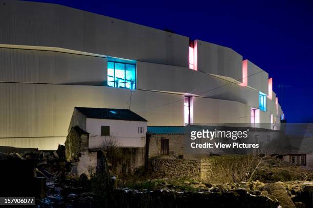 Shopping Mall Centro Comercial Promontorio Architects Guarda Portugal 2009 Curved Exterior Of Illuminated Facade With Existing Housing Shot At Night,...