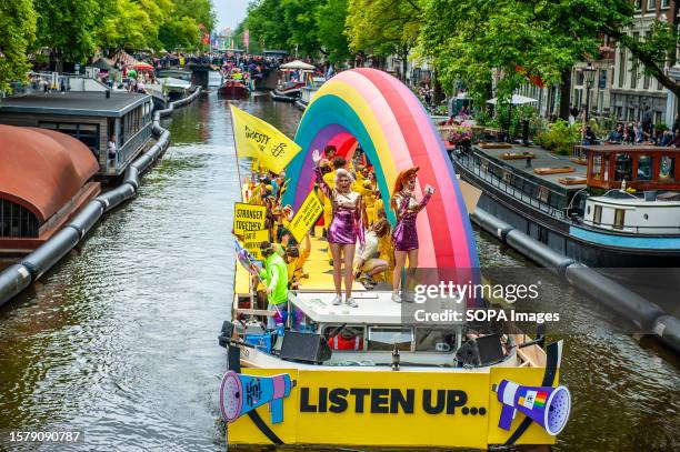 Two drag queens are seen dancing at the front of one of the boats during the event. The Canal Parade starts around noon and takes all afternoon....