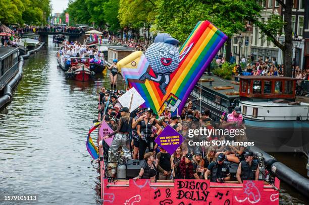 People from a security company are seen dancing on one of the boats during the event. The Canal Parade starts around noon and takes all afternoon....