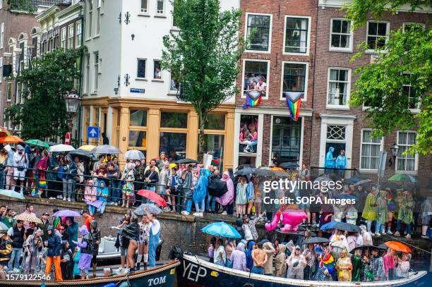 Thousands of people are seen gathering around the canal to celebrate parties during the event. The Canal Parade starts around noon and takes all...