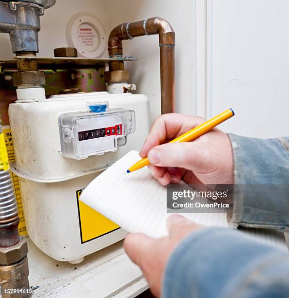 reading the  gas meter - meter stock pictures, royalty-free photos & images