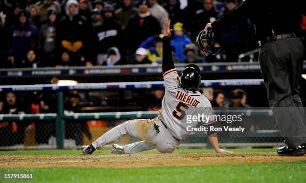 Ryan Theriot of the San Francisco Giants reacts to scoring the go ahead run in the top of the 10th inning during Game 4 of the 2012 World Series...
