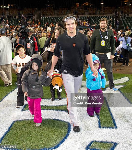 Ryan Theriot of the San Francisco Giants is seen on the field with his daughters after Game 4 of the 2012 World Series against the Detroit Tigers on...