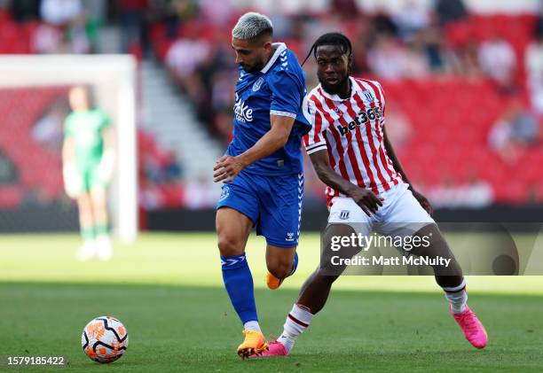 Neal Maupay of Everton battles for possession with Josh Onomah of Stoke City during the pre-season friendly match between Stoke City and Everton at...
