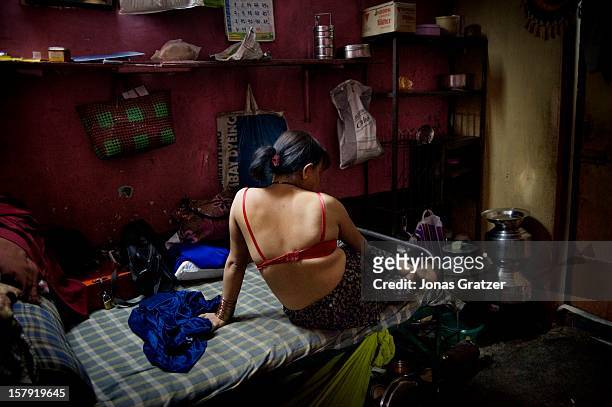 An HIV infected sex worker inside a room in a brothel in the city of Nashik. The women who work in this brothel may have between 20 to 50 customers...