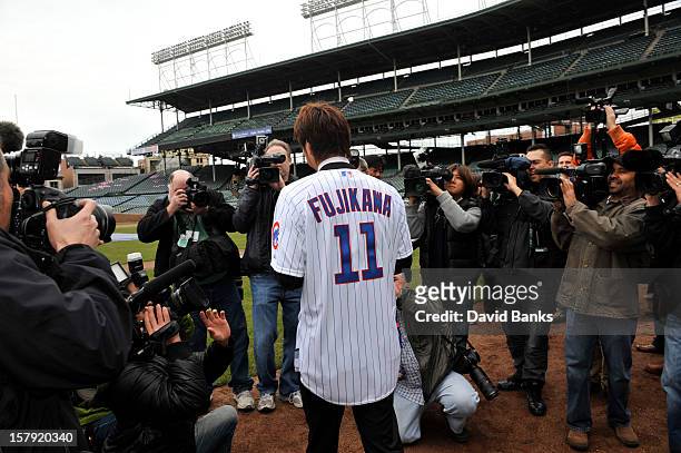 Chicago Cubs new pitcher Kyuji Fujikawa walks onto the field for photos on December 7, 2012 at Wrigley Field in Chicago, Illinois.